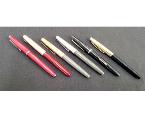 PARKER 51 FOUNTAIN PENwith a red plastic body and a gold coloured metal lid with a broken arrow clip, a Parker 61 fountain pe