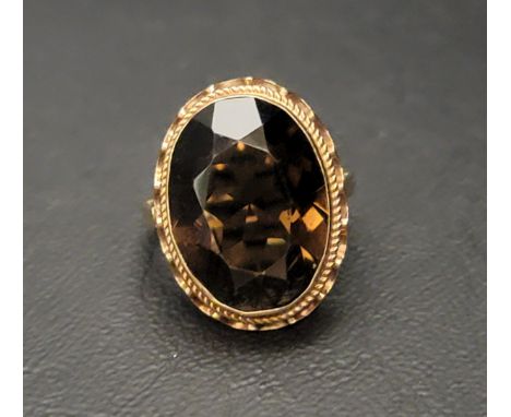 SMOKY QUARTZ DRESS RINGthe large oval cut topaz measuring approximately 17.7mm x 13.2mm x 7.8mm, in nine carat gold shank, ri