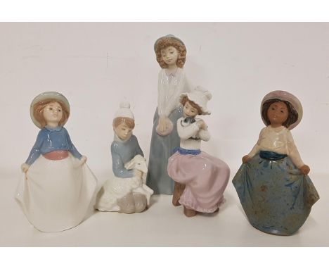 FOUR NAO FIGURINESincluding a girl in a long skirt and hat, 24cm high, girl seated holding a puppy, 17cm high, girl holding h