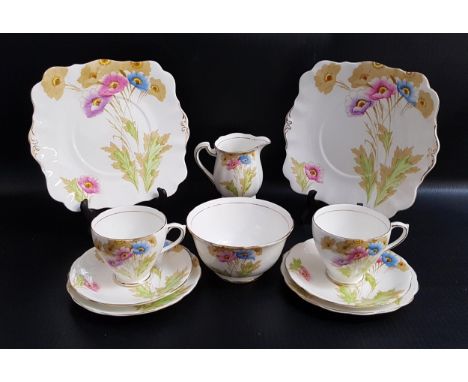 ROYAL STANDARD CHINA TEA SETdecorated with colourful poppies with gilt highlights, comprising twelve tea cups, eleven saucers