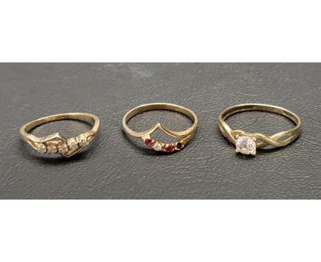 THREE GOLD STONE SET RINGS comprising an unmarked gold diamond set ring with a geometric design, a ruby and CZ set ring with 