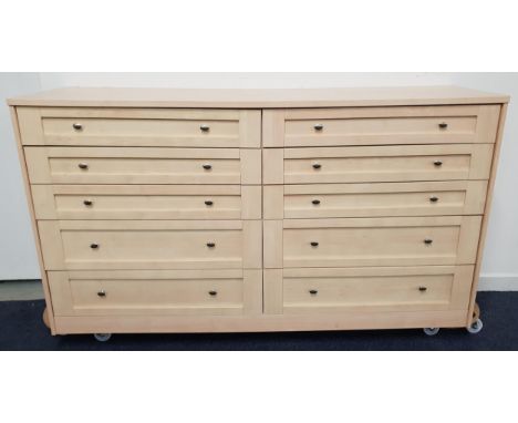 LARGE LIGHT OAK EFFECT CHEST OF DRAWERSwith an arrangement of ten drawers, standing on a plinth base, 100cm x 182cm 