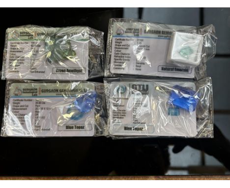 8.25ct natural emerald, 76.5ct blue topaz, 82.75ct green amethyst & 35ct blue topaz 