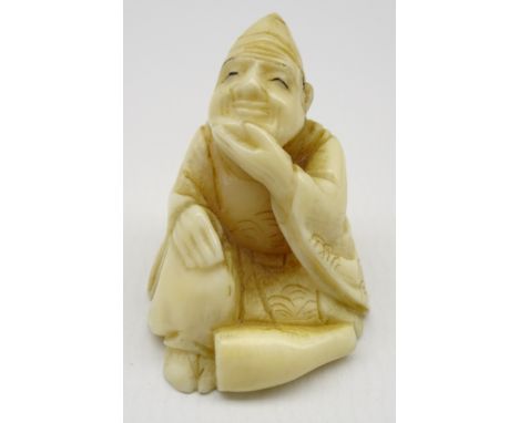 Late 19th Century  Japanese carved ivory Netsuke in the form of a seated figure, signed H3cm