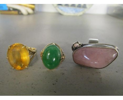 A 14ct gold and jade ring, a gold and citreen ring and a silver and pink quartz ring 