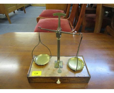 A Victorian walnut and brass scales with base drawer containing weights 