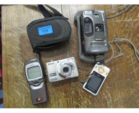 A Nikon Coolpix digital camera, an Olympus Trip MD2 camera, Nokia vintage mobile phone and one other 