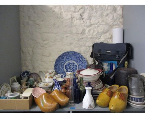 Miscellaneous items to include a blue and white charger, vintage glass and pottery bottles, clogs, two table lamps, ornaments