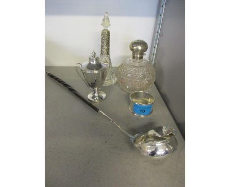 Two silver topped dressing table bottles, a silver trophy, a silver napkin ring and a white metal coin toddy ladle with whale