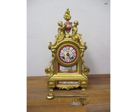 A late 19th century French gilt spelter cased mantle clock with porcelain panels and dial 