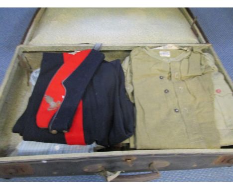 A vintage suitcase containing a Royal Artillery cap with matching trousers, various military undergarments and other clothing