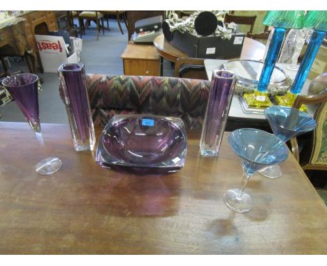 A selection of coloured Waterford table glass to include an amethyst cut glass bowl, two vases and a Champagne/wine flute, al