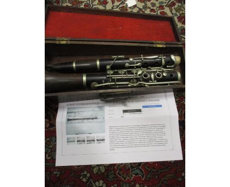 Circa 1900, an Albert System rosewood clarinet by R. Cubitt &amp; Co, London, housed in a mahogany case 