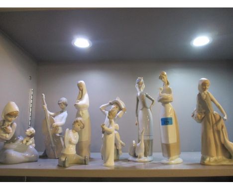 A quantity of Lladro and Nao figures to include a boy playing the cello 