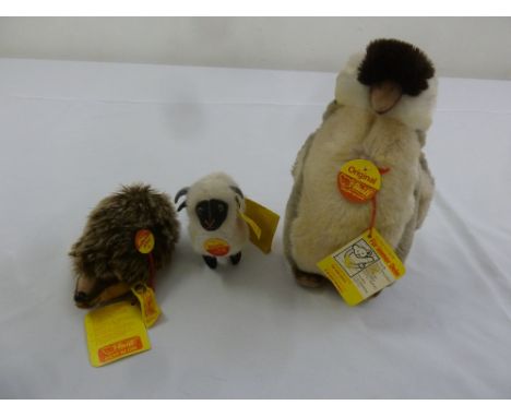 Three Steiff animals, Hedgehog Joggi 1670/40, Lamb Snucki 1520/11 and Penguin 2507/20, all with button and label