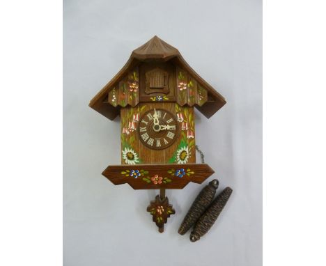 Black Forest cuckoo clock with hand painted flowers and leaves to include two weights and pendulum