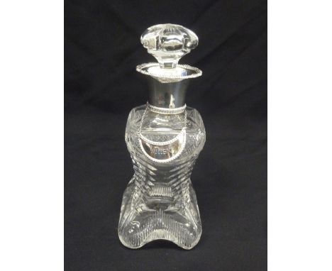 A late Victorian cut glass decanter with drop stopper and silver collar, London 1899 and a silver whisky label
