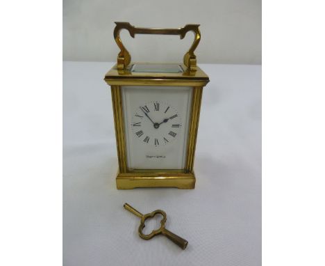 Mappin and Webb carriage clock with white enamel dial, Roman numerals and swing handle, to include key