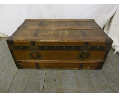 An early 20th century rectangular leather and wood bound steamer trunk with brass fittings, locks and side carrying handles t