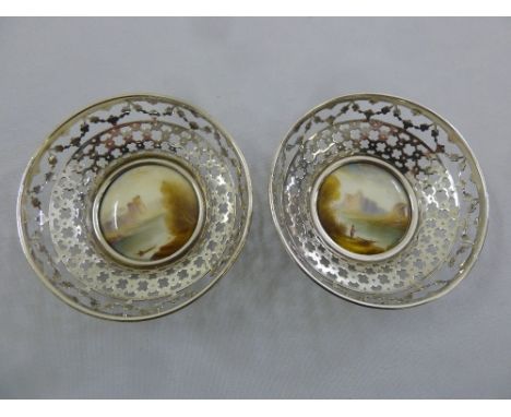 A pair of silver dishes with Royal Worcester hand painted plaques signed Rushton, hallmarked Sheffield 1912
