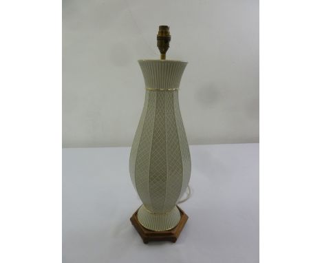 A porcelain green ground lattice design table lamp on raised hexagonal base