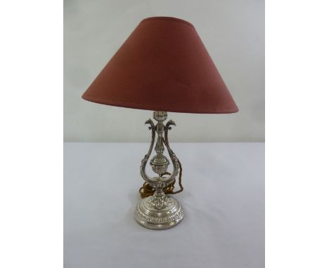 A silver plated Victorian style table lamp on raised circular base to include shade