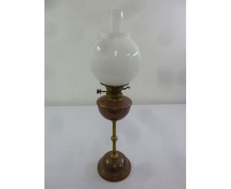 French brass and copper oil lamp with globular glass shade