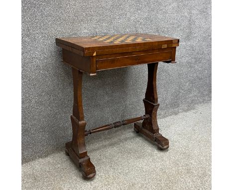 A 19th century mahogany games table having a rectangular top inlaid with an ebony and satinwood chessboard with a revolving a