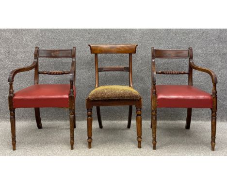 A collection of three chairs to include a pair of Regency mahogany rope back carvers each with carved scrolling arms over a r