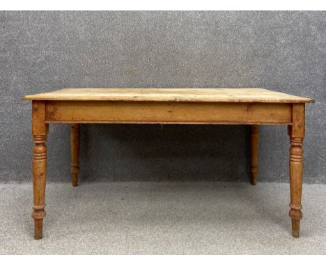 A Victorian pine country farmhouse dining table having a large rectangular top over a single frieze drawer at each end raised