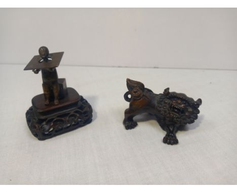 Two items to include a 20th century hand carved Japanese boxwood Netsuke figure in the form of a foo dog or temple lion with 