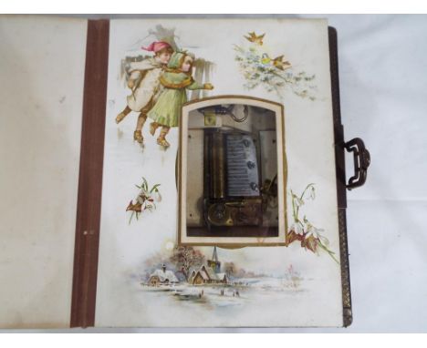A vintage musical photograph album entitled 'The Seasons' with colour decorated pages featuring photograph cut outs. With emb