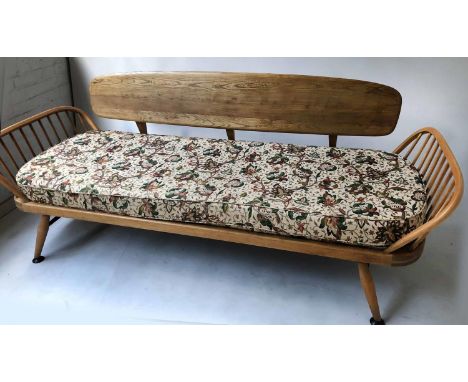 ERCOL SURFBOARD SOFA/DAYBED, 1970s Ercol elm with detachable solid elm oval back and outswept supports, 208cm W. 