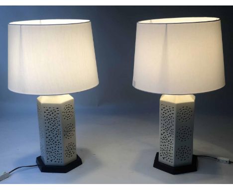 RETICULATED LAMPS, a pair, Chinese hexagonal pierced ivory coloured ceramic on wooden stands, 70cm H with shades. (2) 