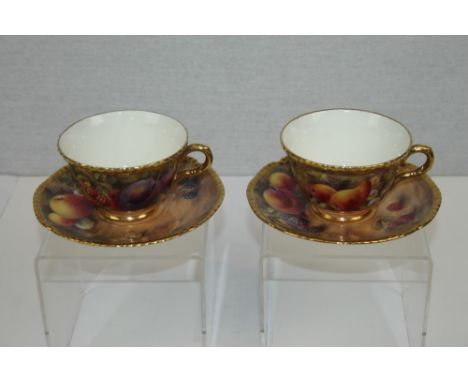 Pair of Royal Worcester cabinet cups and saucers with hand painted fruit decoration, each piece signed 'P. Love' with raised 