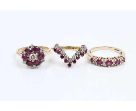 Gold (18ct) ruby and diamond cluster ring with a central brilliant cut diamond surrounded by six round mixed cut rubies and s