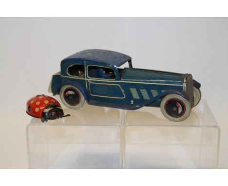 Old tinplate clockwork toy car and a tinplate Gama German Ladybird toy