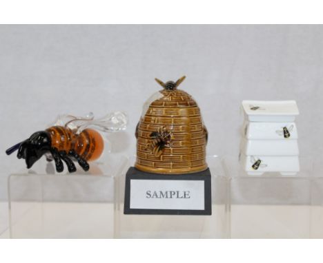Collection of ceramic beehive form honey pots, together with an accompanying book and a glass bee paperweight (12)