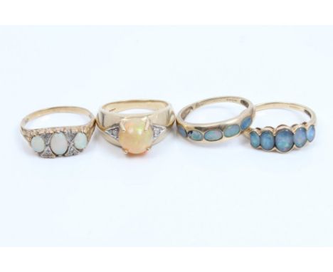 Gold (9ct) three stone opal ring, gold (9ct) jelly opal ring and two other opal rings (4)