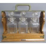 Betjemann 'The Tantalus' containing 3 decanters (one damaged and missing key)