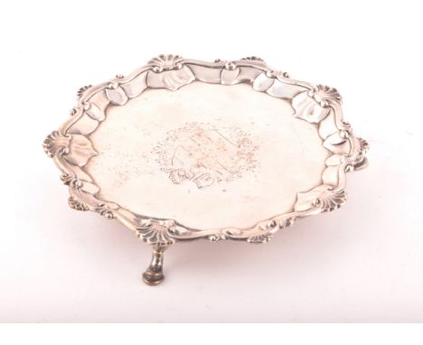 A George III footed silver salver, ornate shell rim, engraved detail to surface, hallmarked for London 1769 by 'I.C', 16.6 cm