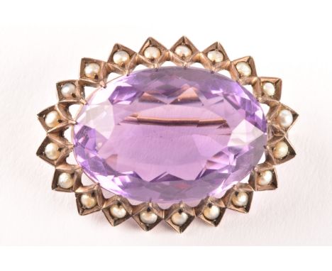A yellow metal Amethyst and pearl seed brooch, set to centre with a oval amethyst with an approximate weight of 20.00 carats,