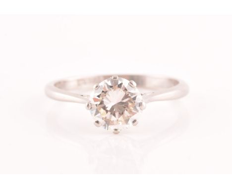 A platinum diamond solitaire ring, set to centre with a round brilliant cut diamond with an approximate weight of 1.50 carats