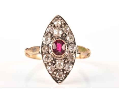 A 18ct yellow gold and silver marquise cluster ring, set to centre with a oval old cut ruby with an approximate weight of 0.3
