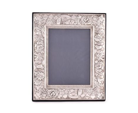 An Elizabeth II silver photo frame, hallmarked London 1999 by GMG, heavily embossed flower and butterfly border, 34cm x 28cm.