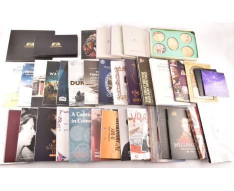 A collection of commemorative silver coins, including a 2022 Platinum Jubilee Photographic Silver Proof Coin Collection; a 20