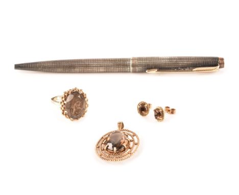 A 9ct yellow gold dress ring, set to centre with a oval smoky quartz with an approximate weight of 8 carats, size P, a 9ct ye