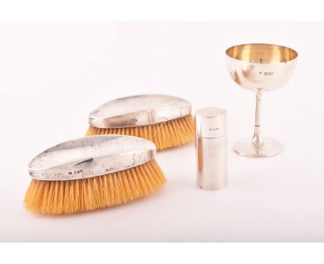 A group of silver items, including a coin case, hallmarked for London 1909 by&nbsp;Samuel Jacob, 8.3cm high, two brushes, one