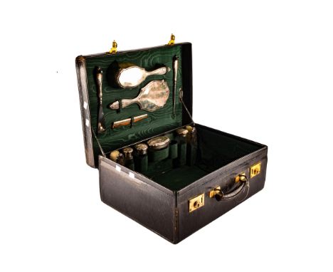 A travelling leather suitcase, with fitted silver interior, inlaid with green material, by Goldsmiths &amp; Silversmiths comp