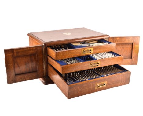 An early 20th century oak cased canteen of cutlery, with three drawers including twelve places settings, silver cutlery mainl